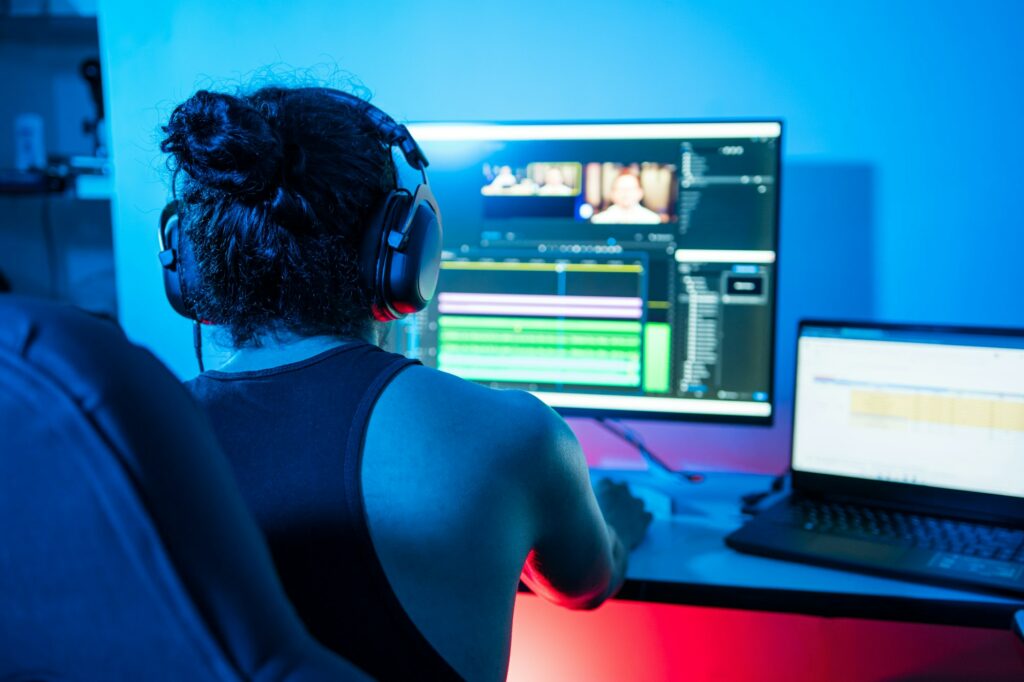 Video editor editing a commercial. Person working from home at night